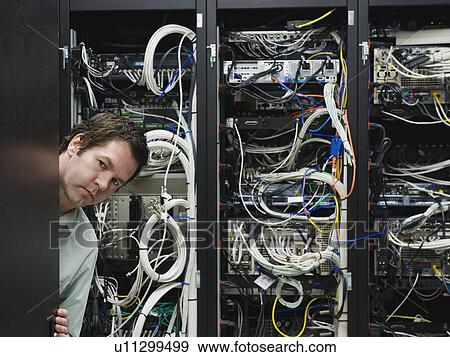 Stock Photo - Man working in data center. Fotosearch