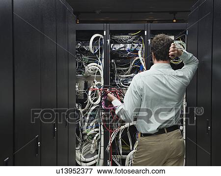 Stock Photo - Man working in data center. Fotosearch