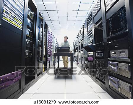 Stock Photo - Man working in data center. Fotosearch