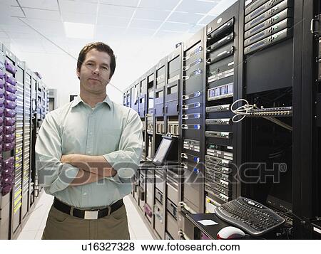 Stock Photo - Man working in data center. Fotosearch