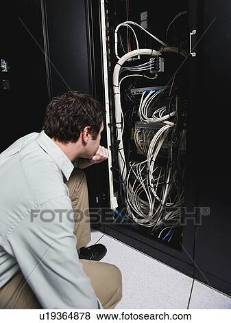 Stock Photo - Man working in data center. Fotosearch