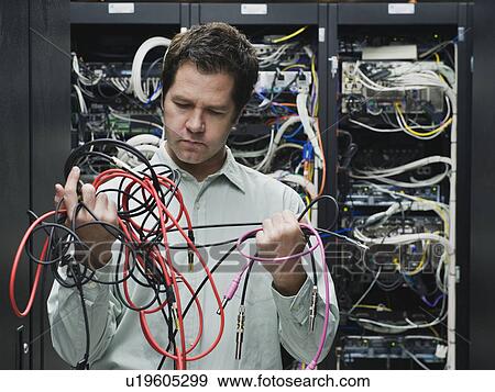Man working in data center View Large Photo Image Stock Photo - Man working in data center. Fotosearch