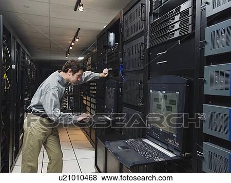 Stock Photo - Man working in data center. Fotosearch