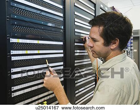 Man working in data center View Large Photo Image Stock Photo - Man working in data center. Fotosearch