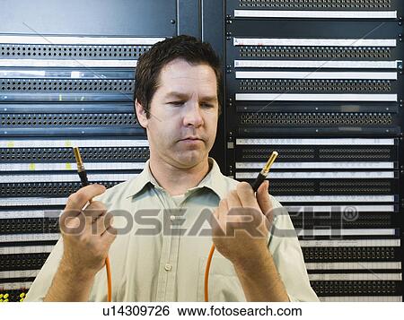 Man working in data center View Large Photo Image Stock Photograph - Man working in data center. Fotosearch