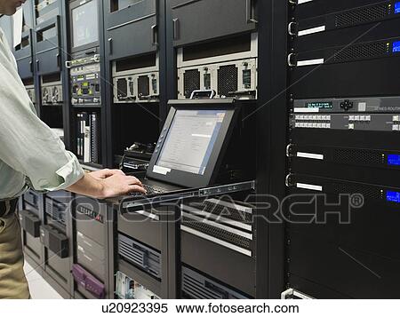 Man working in data center View Large Photo Image Stock Photography - Man working in data center. Fotosearch