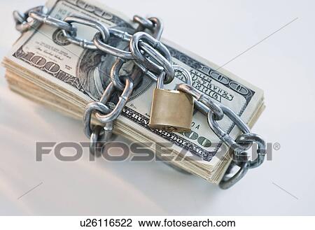 Stock Image - Money wrapped with lock and chain. Fotosearch