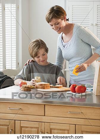 Mother and child preparing food View Large Photo Image Stock Photo - Mother and child preparing food. Fotosearch