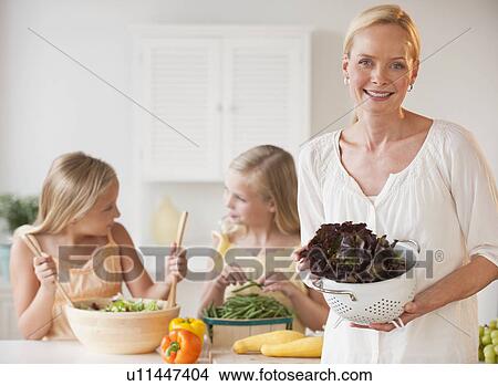 Mother and daughters in the kitchen View Large Photo Image Picture - Mother and daughters in the kitchen. Fotosearch