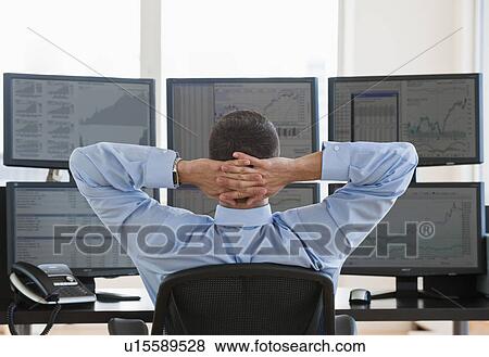 Stock Photo - Relaxed male trader at work. Fotosearch
