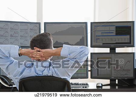 Stock Photo - Relaxed male trader at work. Fotosearch