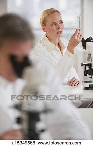 Stock Photo - Researchers working in lab. Fotosearch