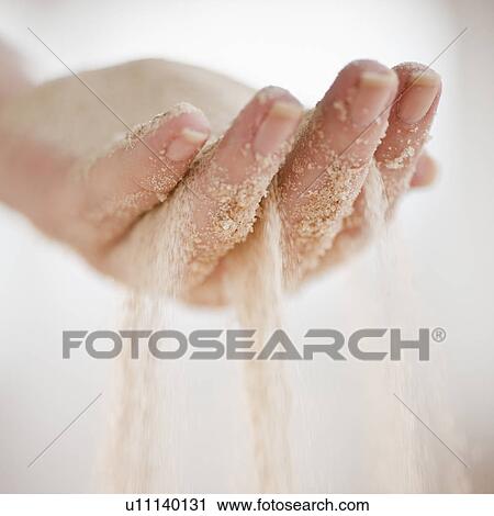 Sand grains falling through hand View Large Photo Image Stock Image - Sand grains falling through hand. Fotosearch