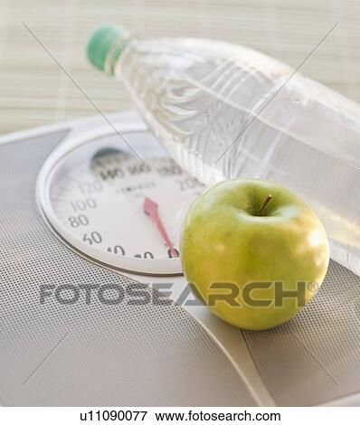 Scale apple and water bottle View Large Photo Image Stock Photo - Scale apple and water bottle. Fotosearch