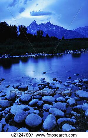 Stock Photo - Scenic view of lake and mountains. Fotosearch