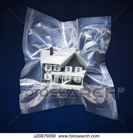 Stock Image - Shrink wrapped toy house. Fotosearch
