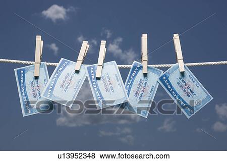 Social security cards on clothes line View Large Photo Image Stock Photo - Social security cards on clothes line. Fotosearch