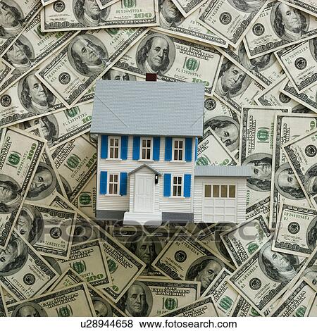 Symbolic house wtih US dollars as background View Large Photo Image Stock Photo - Symbolic house wtih US dollars as background. Fotosearch