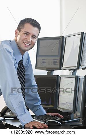 Stock Image - Trader at computer screens. Fotosearch