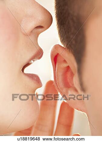 Whispering into ear View Large Photo Image Stock Photo - Whispering into ear. Fotosearch