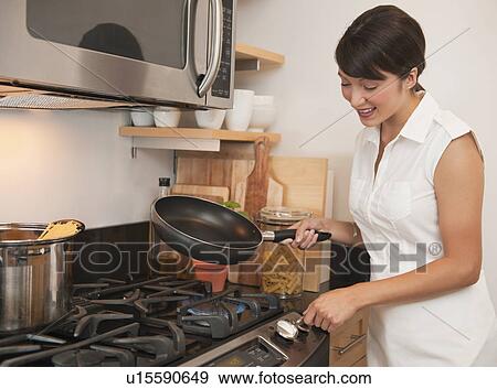 Woman cooking View Large Photo Image Stock Photo - Woman cooking. Fotosearch