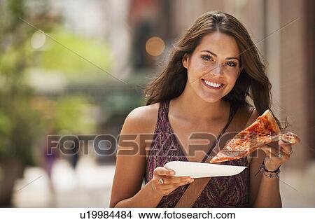 Picture - Woman eating pizza. Fotosearch