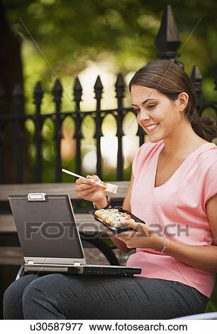 Woman eating Sushi View Large Photo Image Stock Photo - Woman eating Sushi. Fotosearch