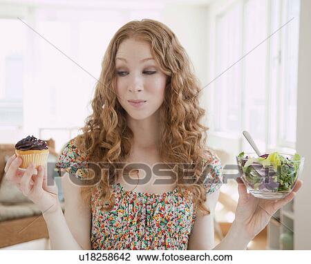 Woman holding food View Large Photo Image Stock Image - Woman holding food. Fotosearch