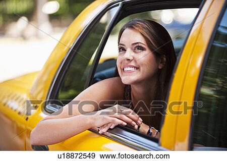 Stock Photo - Woman in taxi. Fotosearch