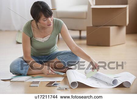 Picture - Woman looking at plans. Fotosearch