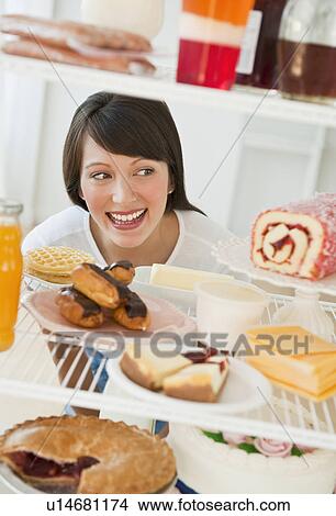 Woman looking at sweets View Large Photo Image Picture - Woman looking at sweets. Fotosearch