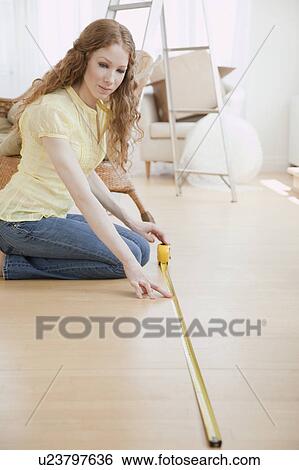 Woman measuring room View Large Photo Image Stock Photograph - Woman measuring room. Fotosearch