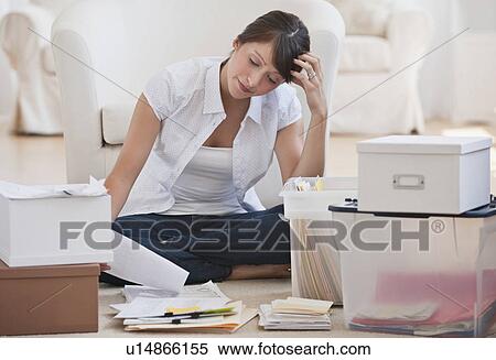 Woman organizing papers View Large Photo Image Stock Photography - Woman organizing papers. Fotosearch