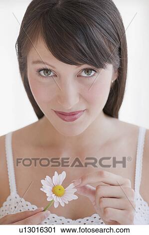 Woman plucking daisy View Large Photo Image Stock Image - Woman plucking daisy. Fotosearch