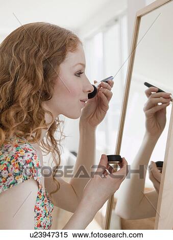 Woman putting on makeup View Large Photo Image Stock Photography - Woman putting on makeup. Fotosearch