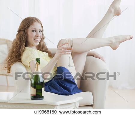 Stock Image - Woman relaxing with drink. Fotosearch