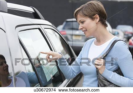 Picture - Woman shopping for car. Fotosearch