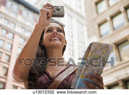 Stock Image - Woman taking picture. Fotosearch