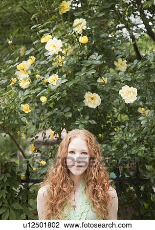 Stock Image - Woman under flowers. Fotosearch