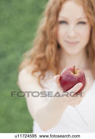 Stock Photography - Woman with apple. Fotosearch