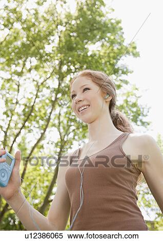 Stock Photography - Woman with MP3. Fotosearch