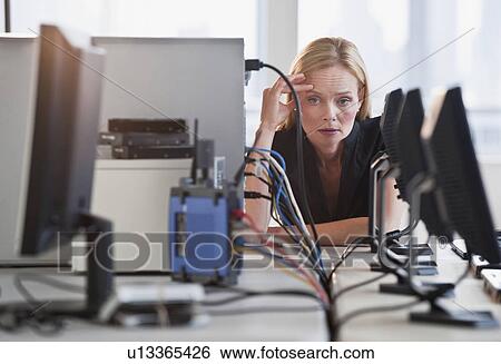 Stock Photograph - Woman with networked computers. Fotosearch