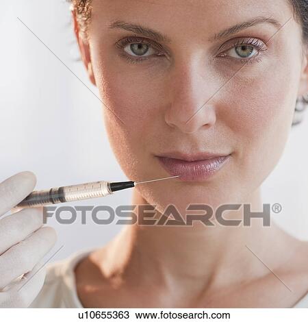 Stock Image - Woman with syringe. Fotosearch