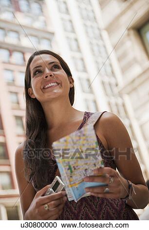 Stock Image - Woman with tourist map. Fotosearch