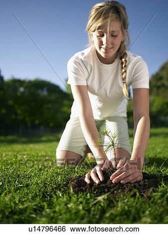 Stock Photograph - Woman working in garden. Fotosearch