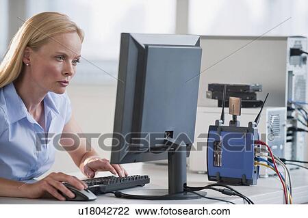 Stock Image - Woman working on computer. Fotosearch