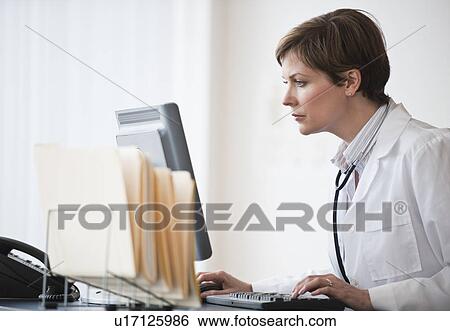 Woman working on computer View Large Photo Image Stock Photograph - Woman working on computer. Fotosearch