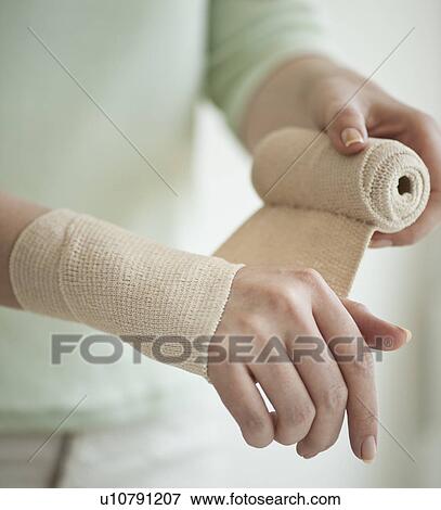 Wrapping hand in tensor bandage View Large Photo Image Stock Photo - Wrapping hand in tensor bandage. Fotosearch