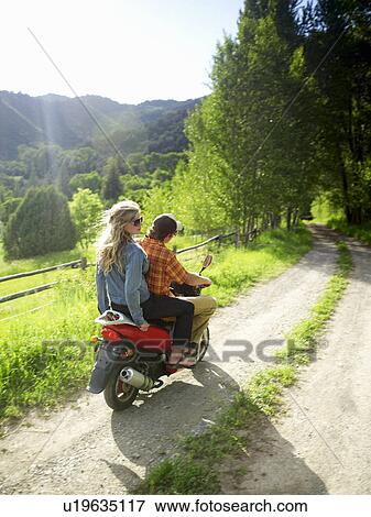 Stock Photo - Young couple on scooter. Fotosearch