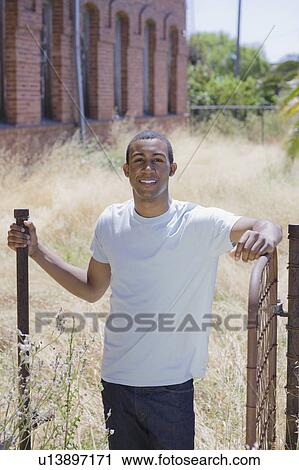 Stock Image - Young man at abandoned building. Fotosearch